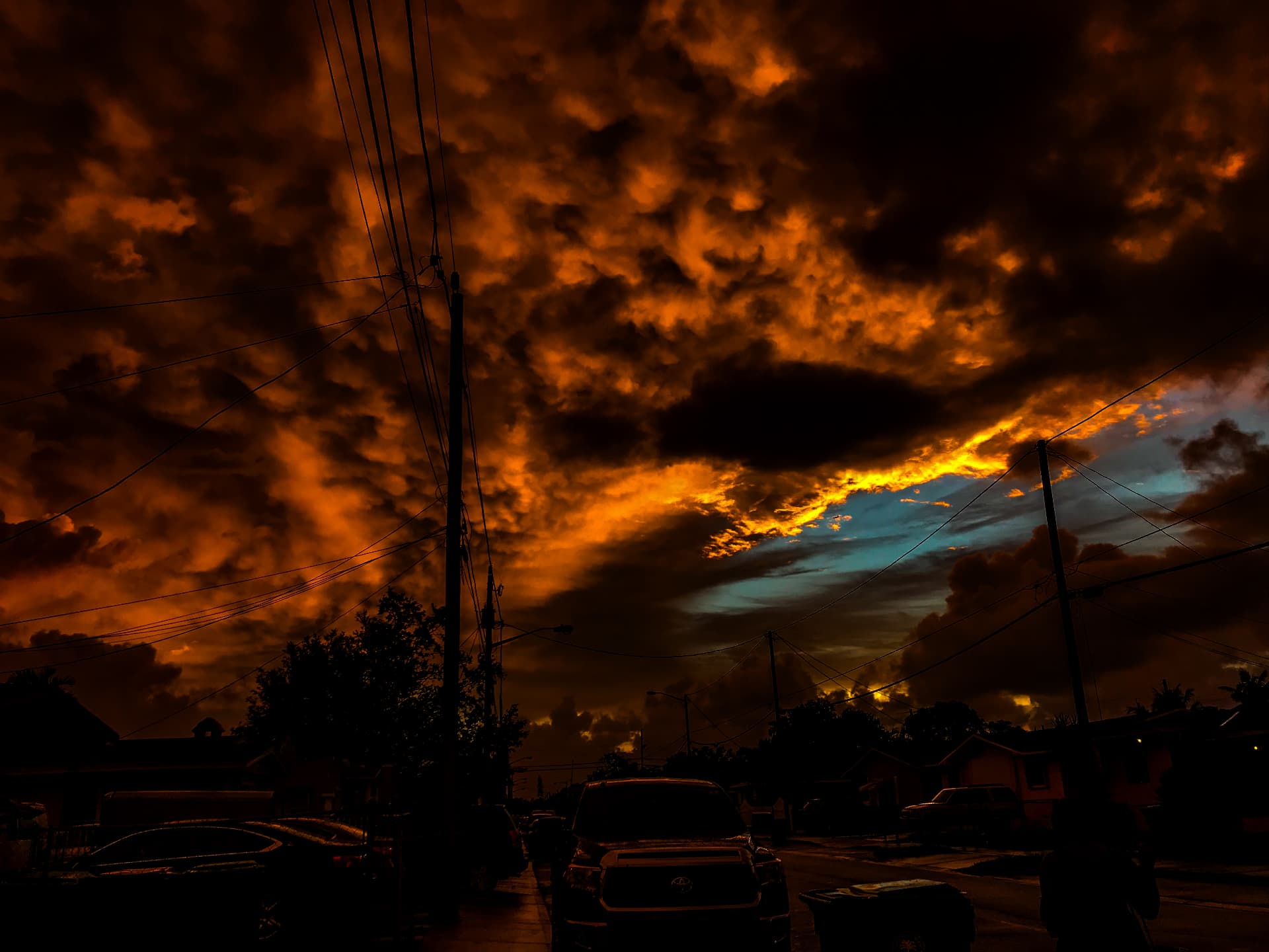 Dark burning orange storm clouds with a slice of blue sky