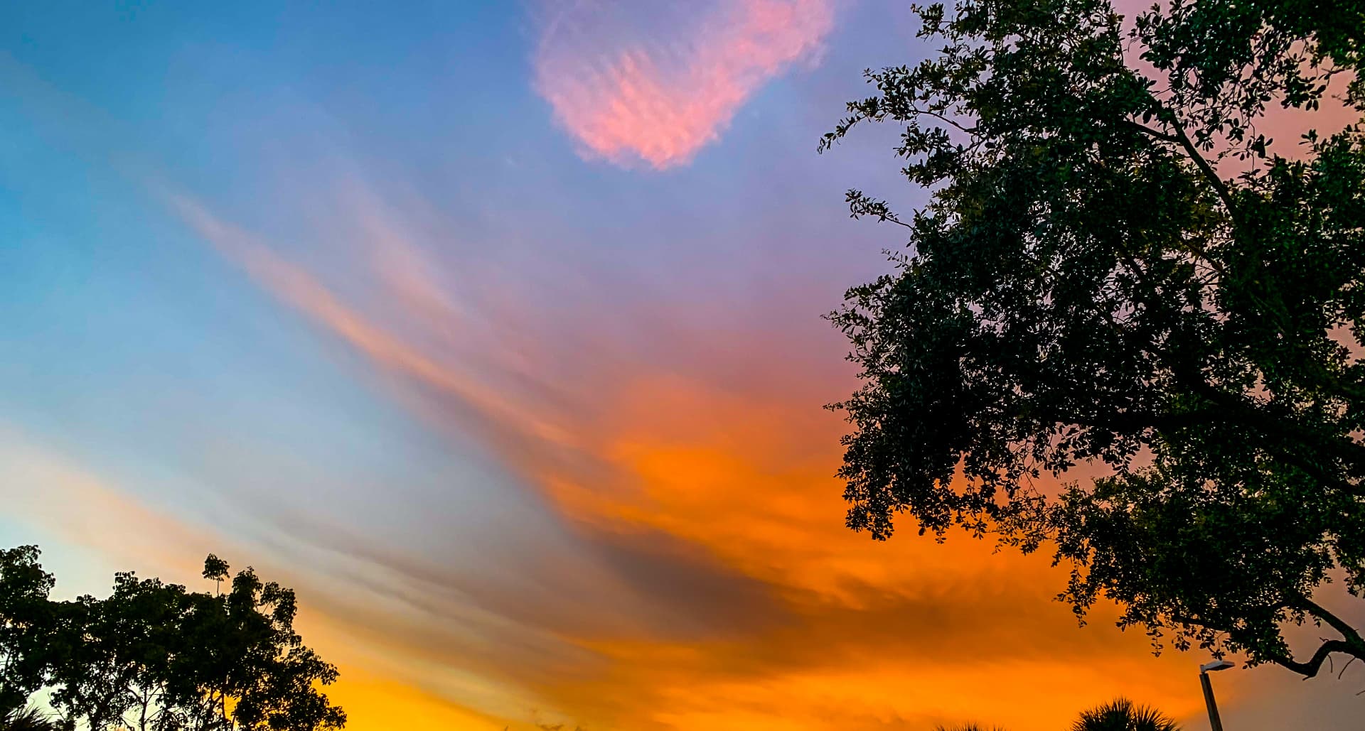 Blue and orange evening sky from the book Sunsets Raised Me